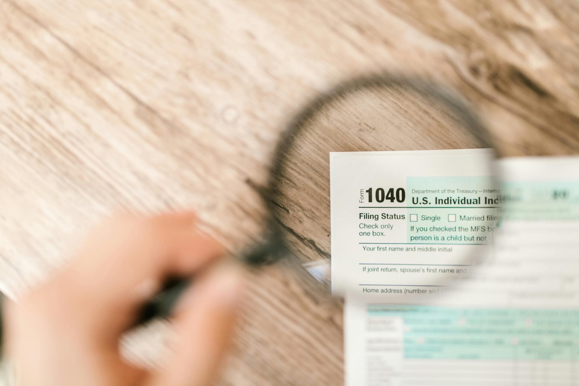 taxes phishing IRS https://www.pexels.com/photo/close-up-shot-of-a-document-through-a-magnifying-glass-7821673/