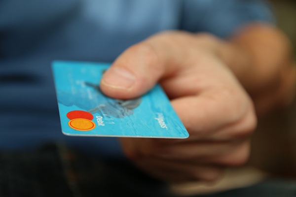 IDTC TIR trends in identity https://www.pexels.com/photo/person-holding-debit-card-50987/