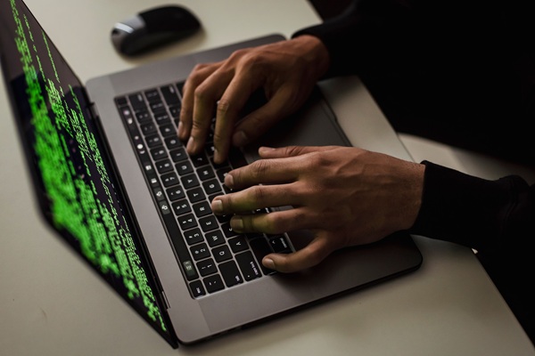Threatdown AI security https://www.pexels.com/photo/crop-cyber-spy-hacking-system-while-typing-on-laptop-5935794/