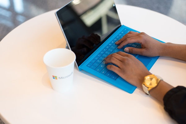 CyberFOX Optimize365 Microsoft 365 security https://www.pexels.com/photo/person-wearing-round-gold-colored-watch-using-black-tablet-computer-with-blue-detachable-keyboard-on-round-white-wooden-table-1181206/
